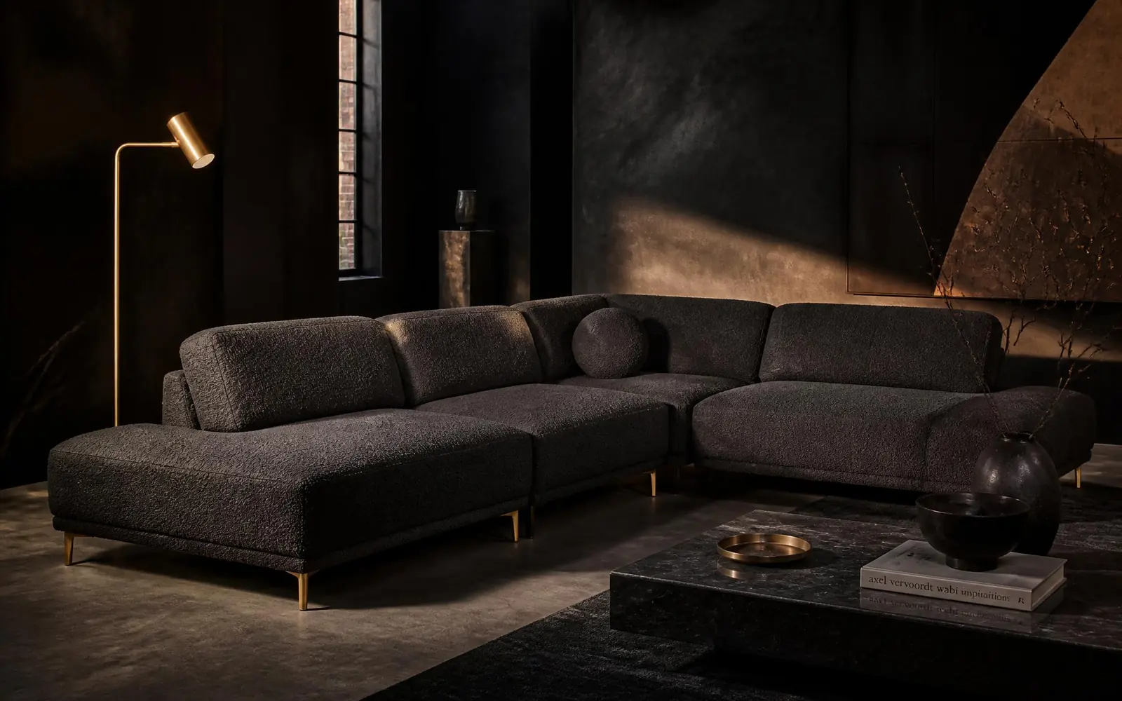 Charcoal bouclé modular sofa in a dark loft living room